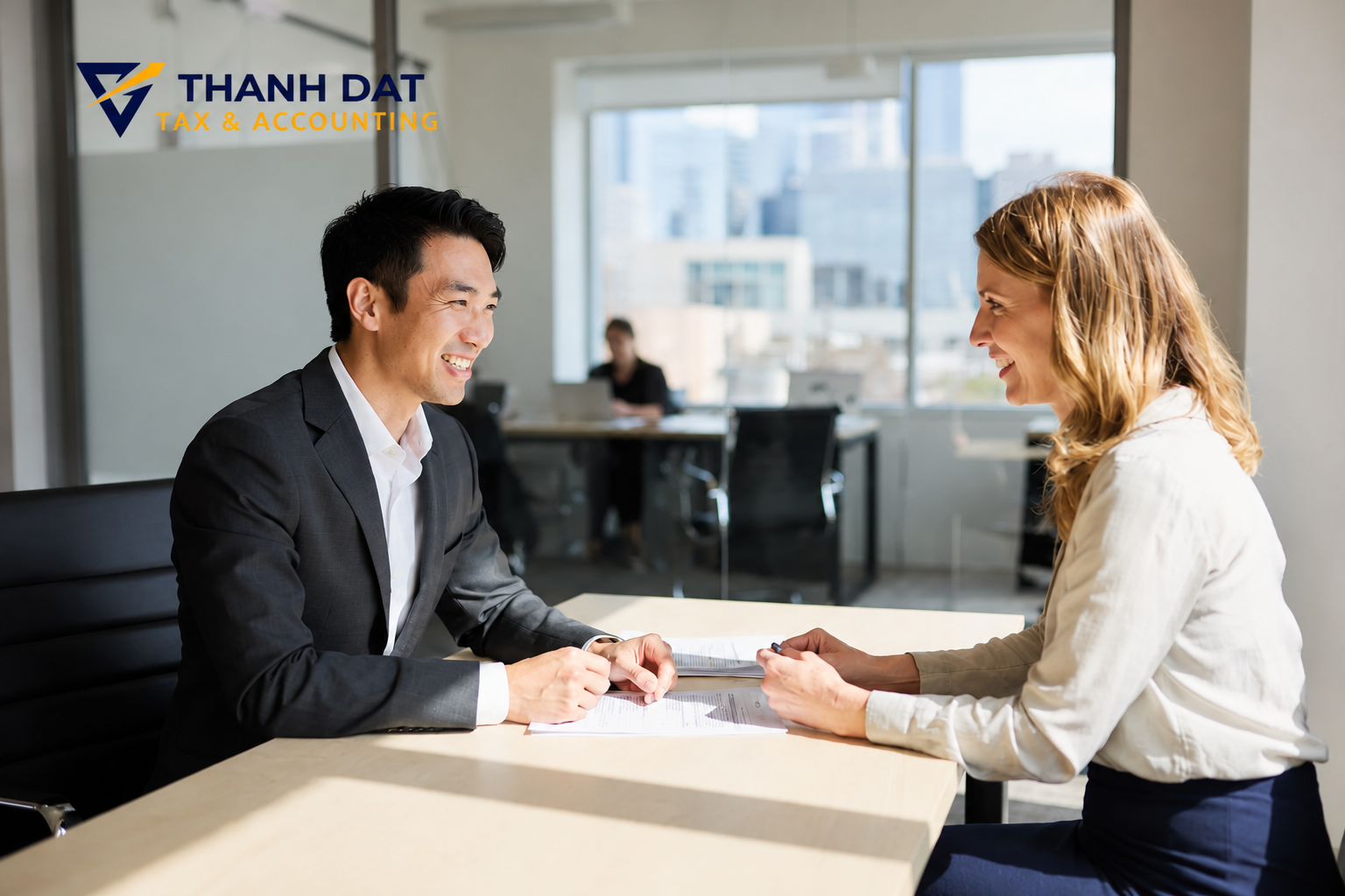 Professional tax advisor consulting with foreign client in modern Seattle office - Thanh Dat Tax