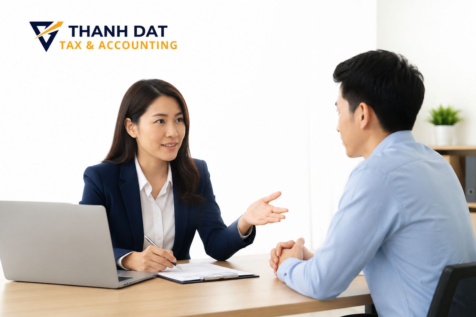 Tax consultant discussing an IRS audit notice with a client at Thanh Dat Tax & Accounting office
