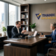Two executives discussing employer duties and payroll services for Washington PFML